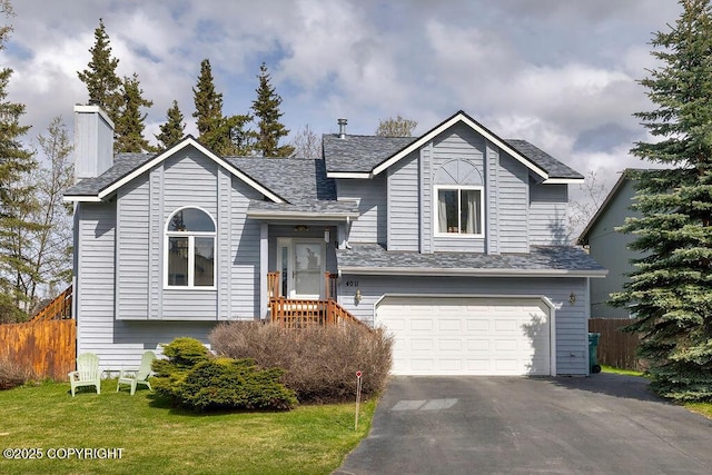 tri-level home featuring a garage, asphalt driveway, a chimney, and roof with shingles