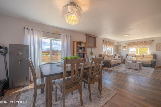 dining area with a chandelier and wood finished floors