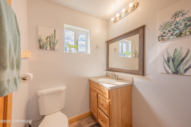 half bathroom featuring toilet and vanity