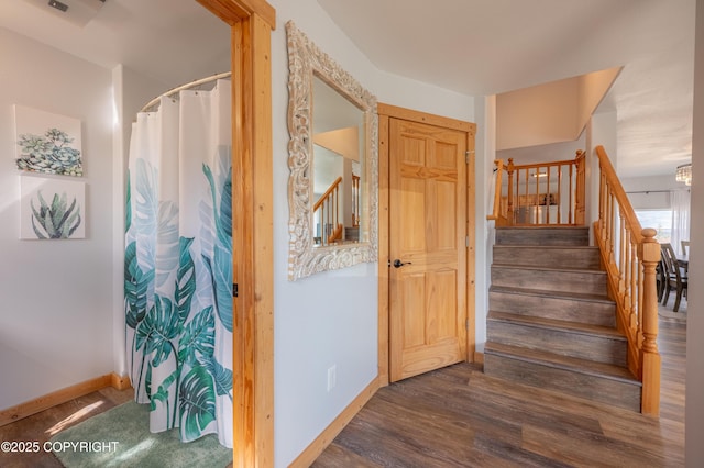 stairs featuring baseboards and wood finished floors