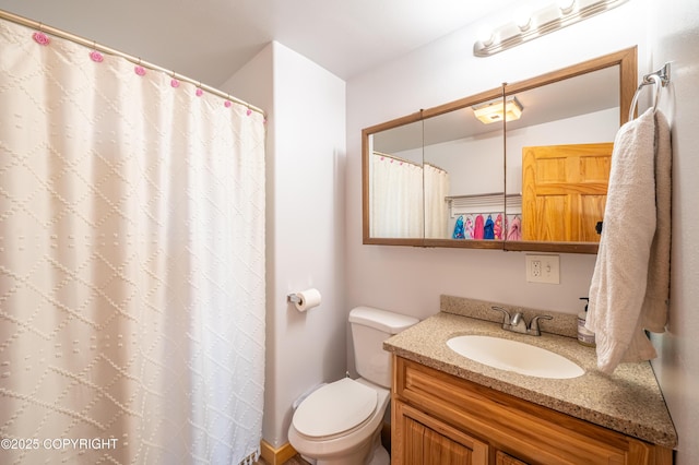 full bathroom with toilet, vanity, and curtained shower