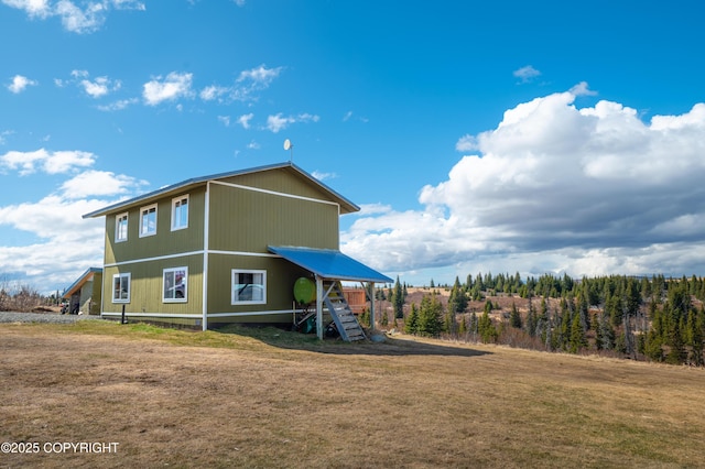 rear view of property with a lawn