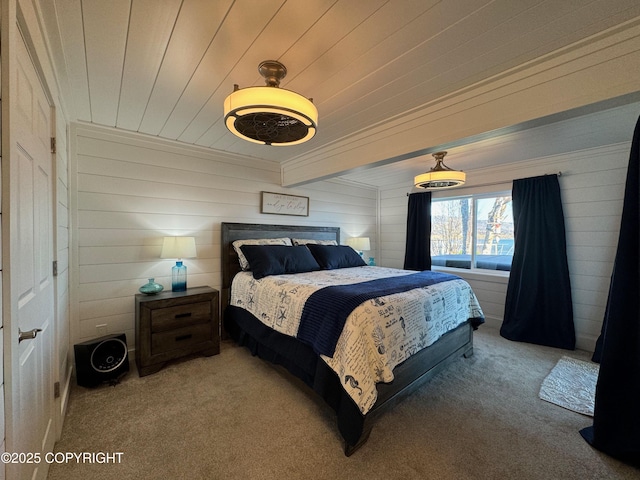 carpeted bedroom featuring wood walls