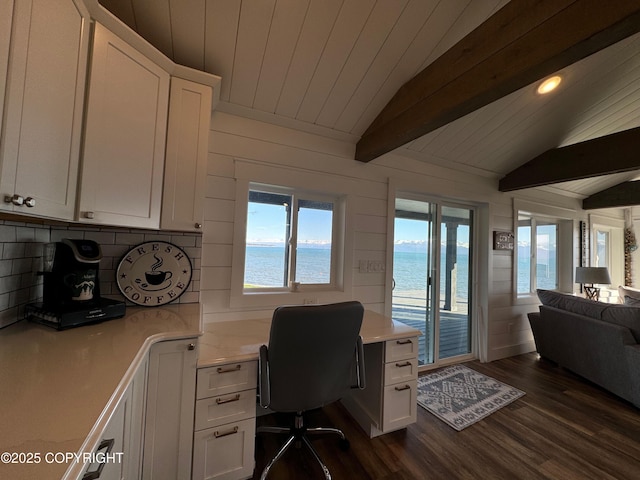 office space featuring vaulted ceiling with beams, wood ceiling, dark wood-type flooring, and a wealth of natural light