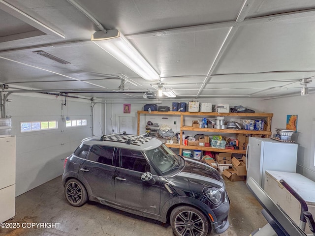 garage with visible vents and a garage door opener
