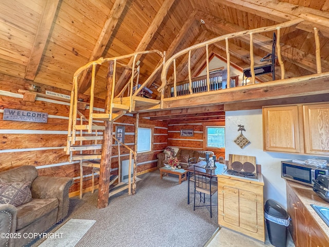unfurnished living room featuring carpet, beamed ceiling, high vaulted ceiling, and wooden ceiling