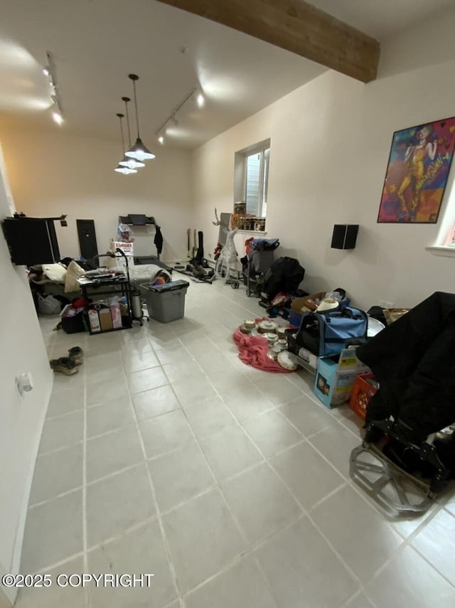 below grade area with track lighting and tile patterned flooring