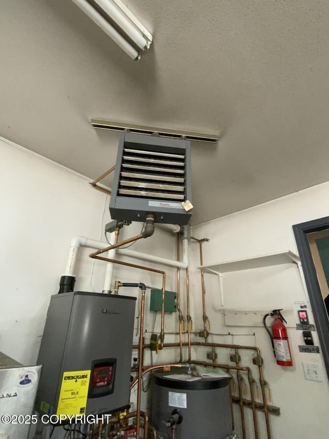 utilities featuring water heater and a heating unit