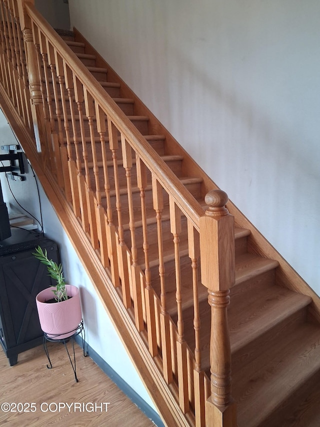 stairway featuring wood finished floors