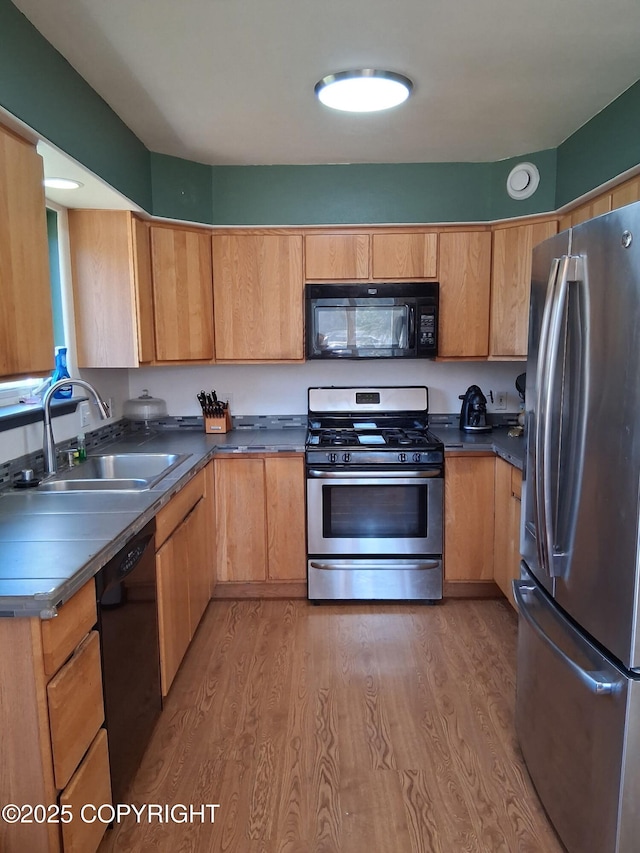 1012 Channel Way, Kenai, AK 99611 - kitchen featuring black appliances, light wood finished floors, and dark countertops