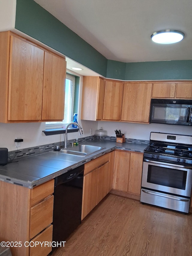 1012 Channel Way, Kenai, AK 99611 - kitchen with black appliances, light wood finished floors, and light brown cabinets