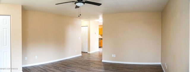 spare room featuring wood finished floors, baseboards, and ceiling fan