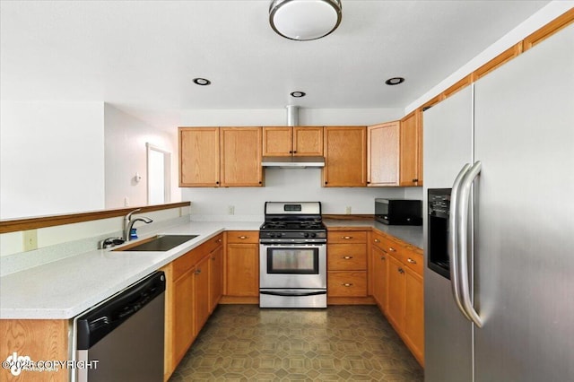 6132 S Northern Lights St, Wasilla, AK 99623 - kitchen with stainless steel appliances, under cabinet range hood, a peninsula, recessed lighting, and light countertops