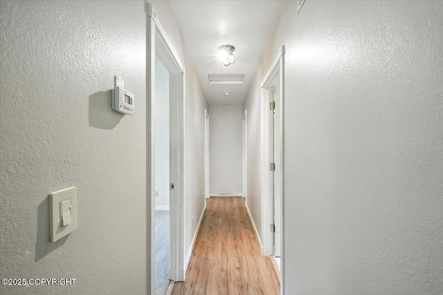 6132 S Northern Lights St, Wasilla, AK 99623 - corridor with light wood finished floors and a textured wall