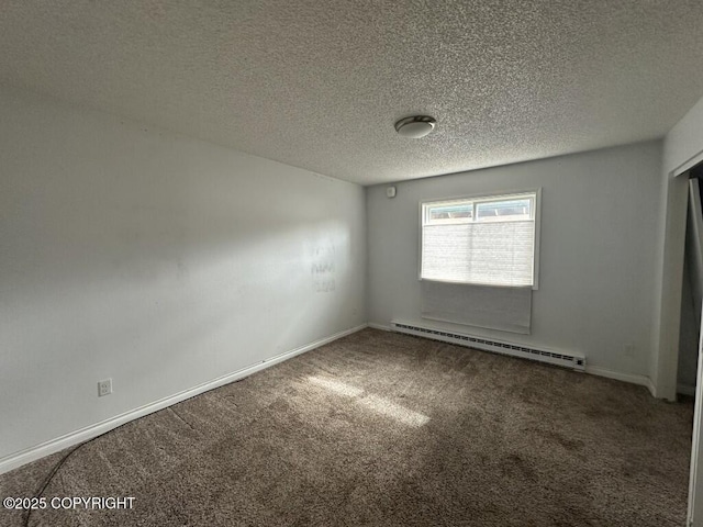 empty room featuring carpet floors, a textured ceiling, a baseboard heating unit, and baseboards