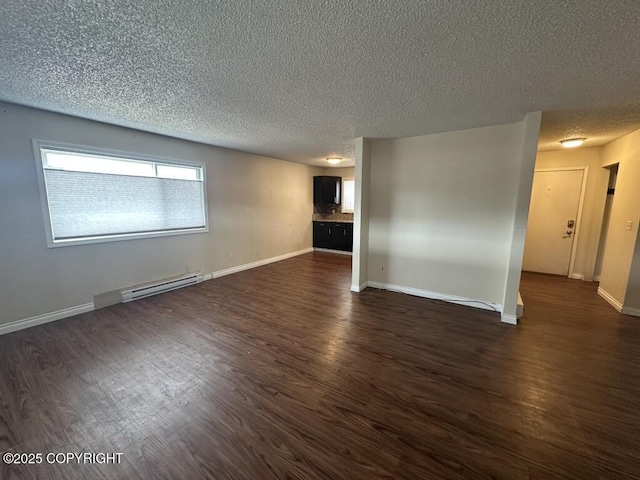 interior space featuring baseboards, a textured ceiling, a baseboard heating unit, and dark wood finished floors