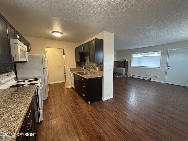 kitchen featuring backsplash, dark wood-style flooring, a textured ceiling, baseboard heating, and white appliances