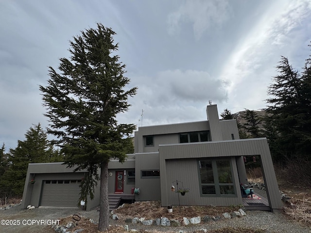 modern home featuring a garage and a chimney