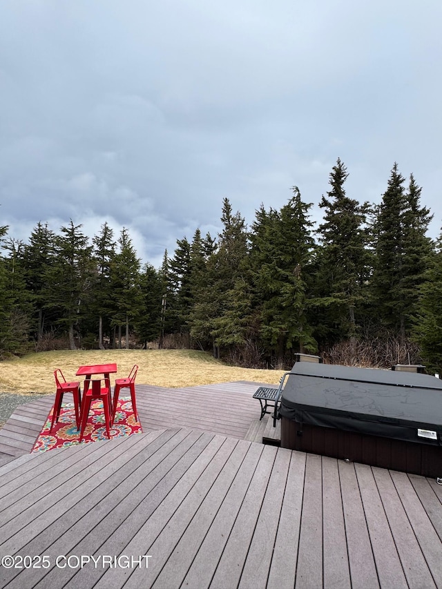 deck with a covered hot tub