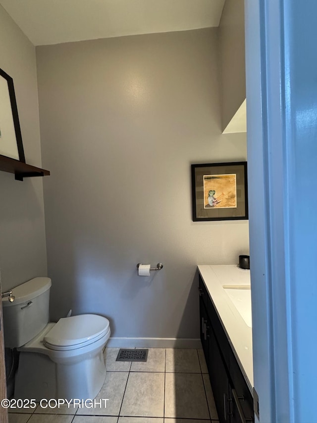 bathroom featuring visible vents, tile patterned floors, baseboards, vanity, and toilet