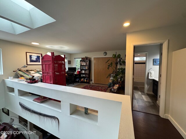 7041 Potter Hts, Anchorage, AK 99516 - kitchen featuring recessed lighting, a skylight, baseboards, and wood finished floors