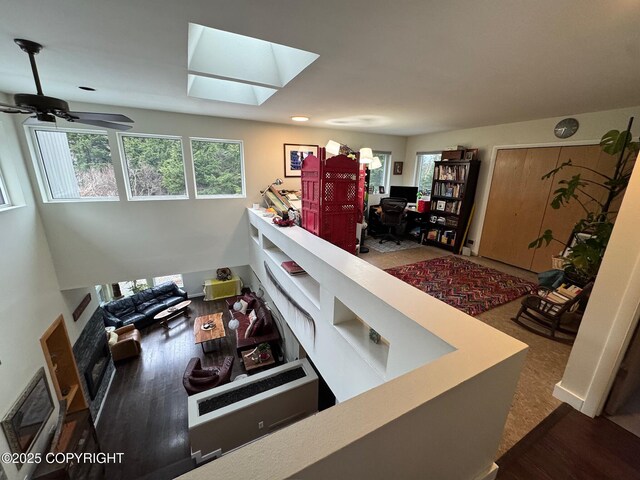 7041 Potter Hts, Anchorage, AK 99516 - interior space featuring a skylight, ceiling fan, and wood finished floors