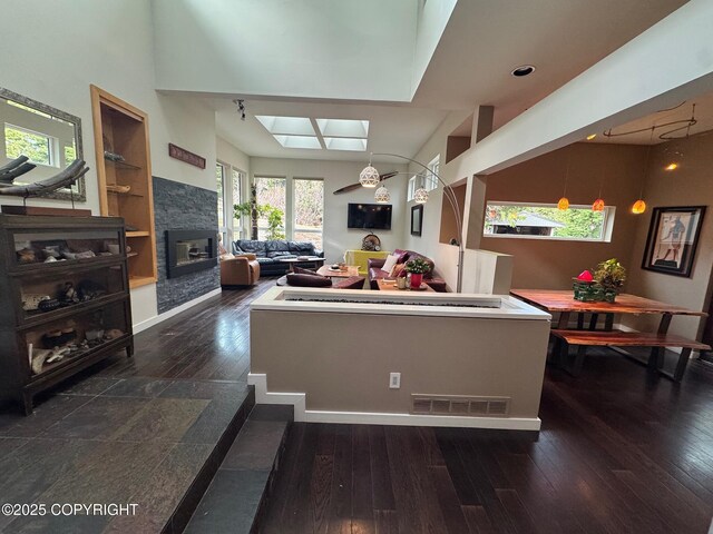 7041 Potter Hts, Anchorage, AK 99516 - living room featuring visible vents, wood-type flooring, a skylight, and a fireplace