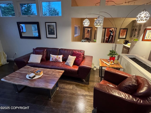 living area featuring baseboards and wood-type flooring