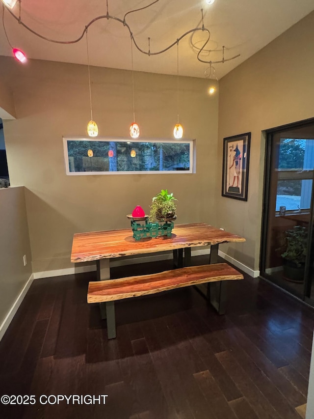 dining space featuring baseboards, dark wood-type flooring, and breakfast area