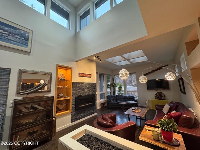 7041 Potter Hts, Anchorage, AK 99516 - living area featuring dark wood-style flooring, a high ceiling, a wealth of natural light, and a fireplace