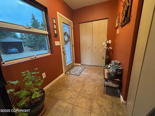entrance foyer with baseboards and tile patterned floors