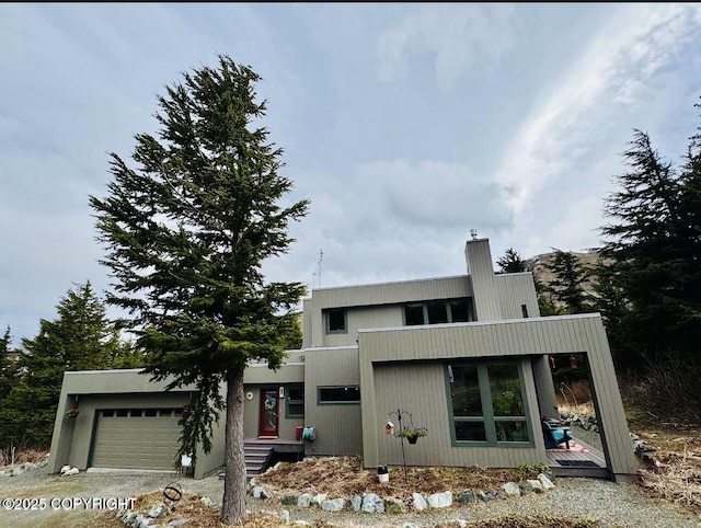 7041 Potter Hts, Anchorage, AK 99516 - contemporary house with an attached garage, driveway, and a chimney