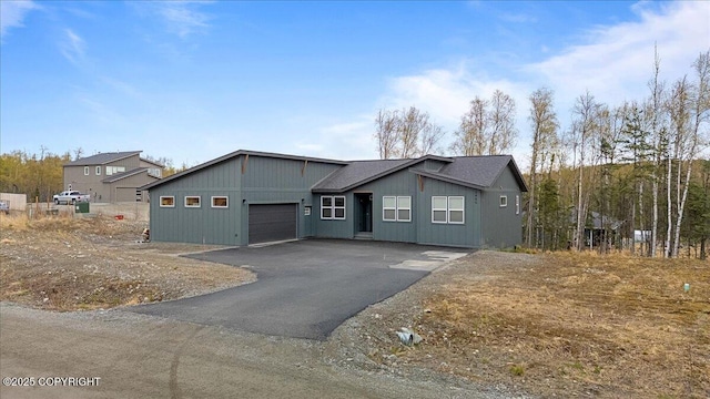 view of front facade featuring a garage and aphalt driveway