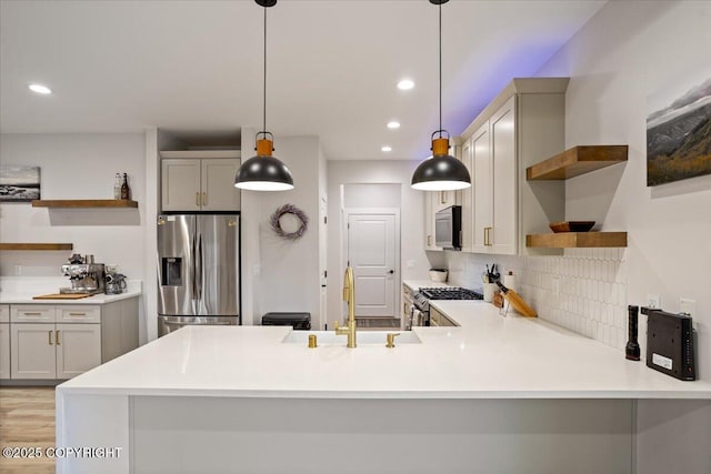 kitchen with open shelves, a sink, backsplash, and stainless steel appliances