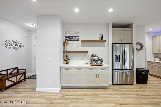 kitchen with open shelves, stainless steel fridge, light wood finished floors, recessed lighting, and baseboards