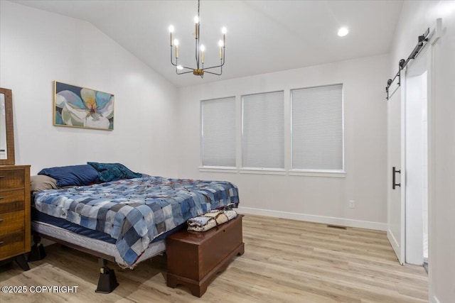 bedroom with vaulted ceiling, a barn door, baseboards, light wood finished floors, and a notable chandelier