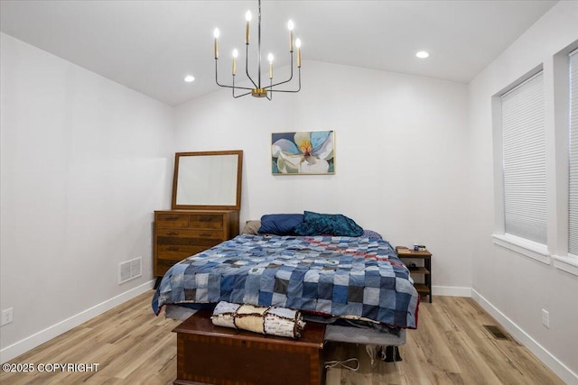 bedroom with visible vents, a notable chandelier, and light wood-type flooring