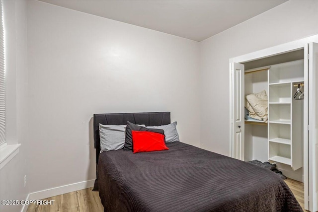 bedroom featuring baseboards and wood finished floors