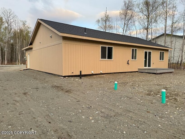 rear view of property featuring a deck