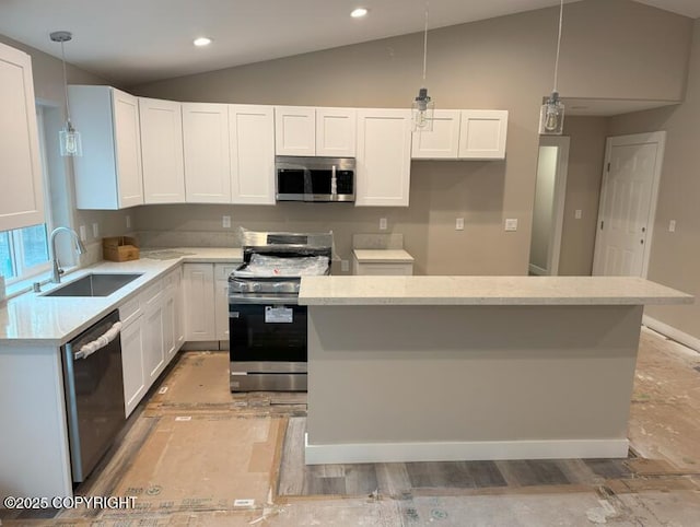 kitchen with stainless steel appliances, a sink, lofted ceiling, white cabinetry, and pendant lighting