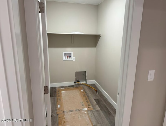 clothes washing area featuring washer hookup, wood finished floors, baseboards, and hookup for a gas dryer