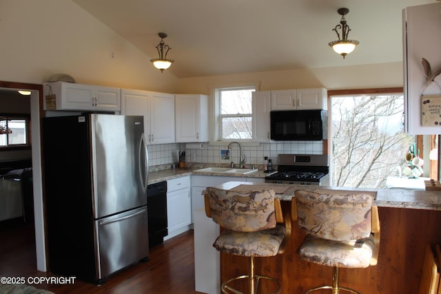 kitchen with a sink, white cabinets, backsplash, and black appliances