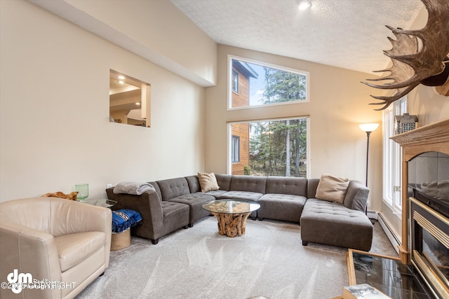 carpeted living room featuring a textured ceiling, a tiled fireplace, and baseboard heating