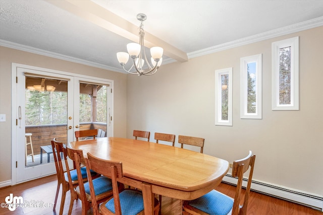 dining area featuring crown molding, an inviting chandelier, french doors, wood finished floors, and a baseboard heating unit