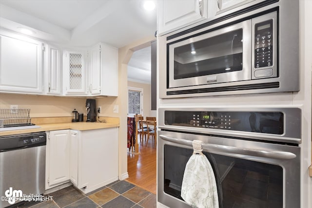 kitchen featuring light countertops, white cabinets, stainless steel appliances, and recessed lighting