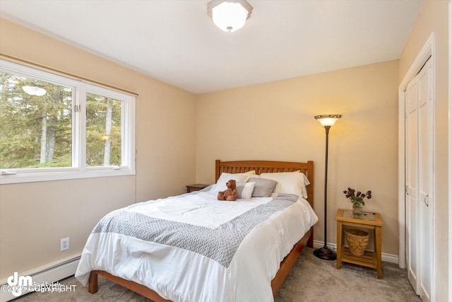 bedroom featuring baseboards, carpet, a closet, and a baseboard heating unit