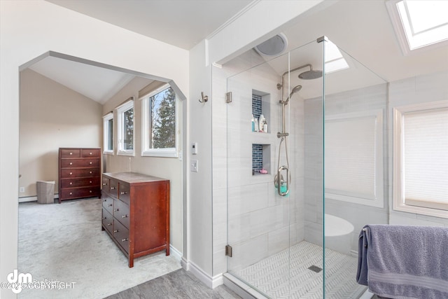 full bathroom with a shower stall, lofted ceiling, and a baseboard radiator