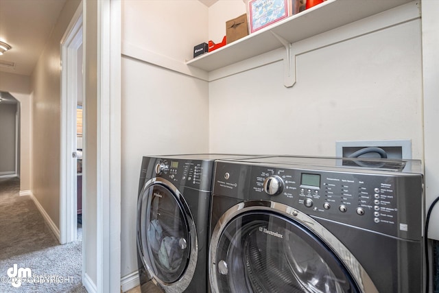 laundry room featuring baseboards, laundry area, carpet flooring, and washer and dryer
