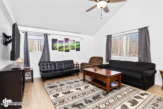 living area featuring ceiling fan, wood finished floors, and high vaulted ceiling