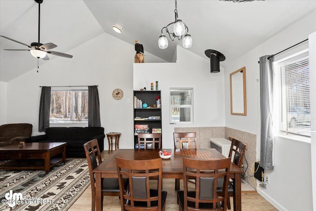 dining area featuring ceiling fan, light wood-style flooring, and lofted ceiling